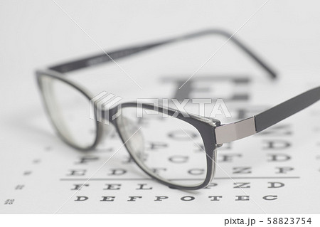 Eyeglasses on eyesight test chart background. 58823754