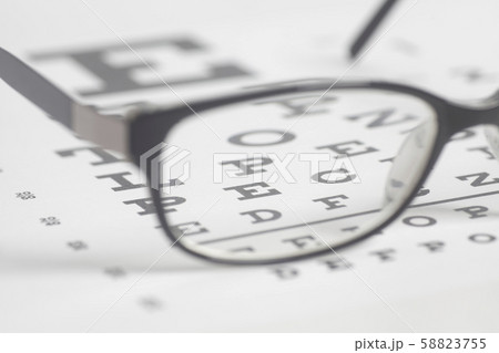 Eyeglasses on eyesight test chart background. 58823755