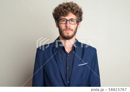 Face of young bearded businessman with eyeglasses in suit 58823767
