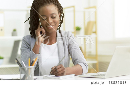 Office Girl Having Phone Conversation With Clients Sitting At Workplace 58825013