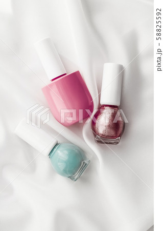 Nail polish bottles on silk background, french Nail polish bottles on silk background, french 58825592