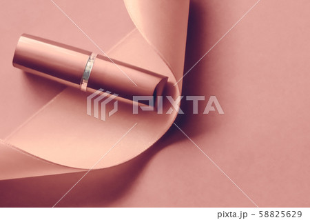 Luxury lipstick and silk ribbon on blush pink 58825629