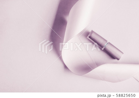Luxury lipstick and silk ribbon on blush purple 58825650