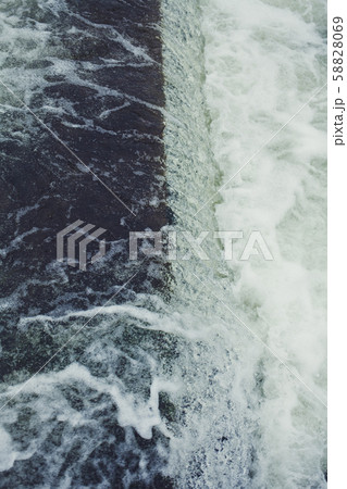 rapid flow of water close-up 58828069