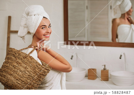 woman holding wicker basket with laundry 58828487
