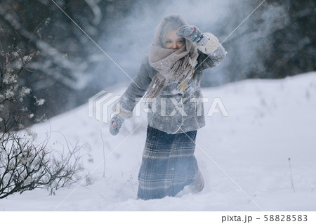 cute little girl in the woods in winter. snowing 58828583