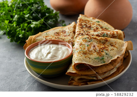 Savory pancakes (crepes) with parsley. 58829232