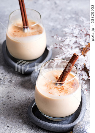 Winter spicy hot drink eggnog in a glasses with Winter spicy hot drink eggnog in a glasses with 58829952