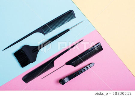 Combs and bleach brushes on pastel colored paper Combs and bleach brushes on pastel colored paper 58830315