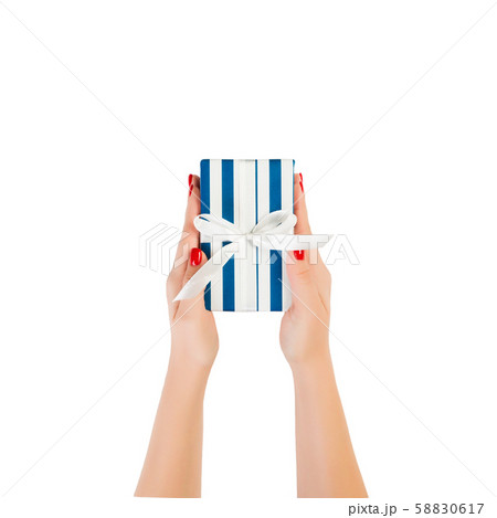 Woman hands give wrapped Christmas or other 58830617