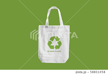 white cloth bag with Recycle sign logo and words "No more Plastic" on green blackground.eco friendly concept white cloth bag with Recycle sign logo and words "No more Plastic" on green blackground.eco friendly concept 58831458