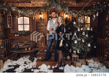 Beautiful couple with champagne under Christmas Beautiful couple with champagne under Christmas 58833776
