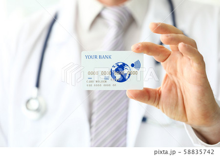 Male GP holding banking card in arm Male GP holding banking card in arm 58835742