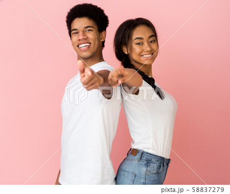 Hey, you! Overjoyed couple pointing fingers at camera Hey, you! Overjoyed couple pointing fingers at camera 58837279