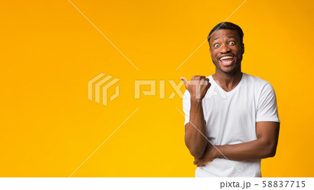 Funny Man Pointing Thumbs At Free Space, Yellow Background, Panorama Funny Man Pointing Thumbs At Free Space, Yellow Background, Panorama 58837715