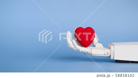 Medical robotics and science fiction concept. Robot hand holding red heart Medical robotics and science fiction concept. Robot hand holding red heart 58838102