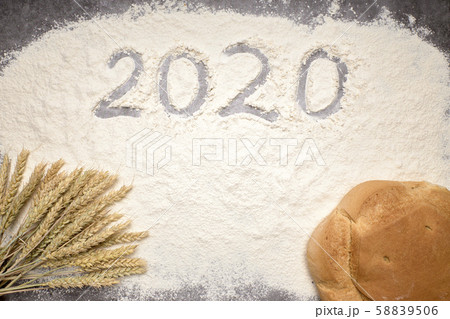 Happy New Year 2020. Symbol from number 2020 and wheat on farina background Happy New Year 2020. Symbol from number 2020 and wheat on farina background 58839506