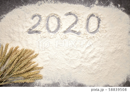 Happy New Year 2020. Symbol from number 2020 and wheat on farina background 58839508
