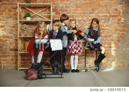 Group of kids spending time after school together. Handsome friends resting after classes. 58839673