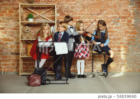 Group of kids spending time after school together. Handsome friends resting after classes. Group of kids spending time after school together. Handsome friends resting after classes. 58839680