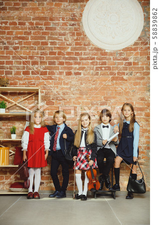 Group of kids spending time after school together. Handsome friends resting after classes. Group of kids spending time after school together. Handsome friends resting after classes. 58839862