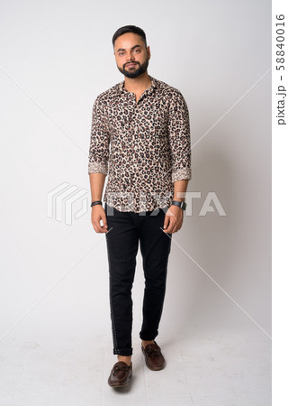 Full body shot of young bearded Indian man 58840016