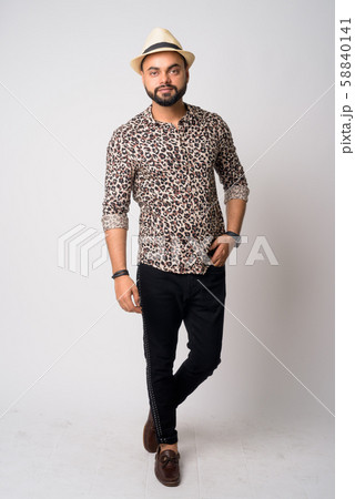 Full body shot of young bearded Indian man with hat 58840141