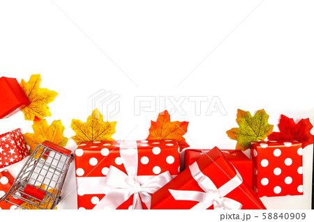 Frame made of maple leaves and gift boxes on white background. Thanksgiving day concepts, Christmas Concepts, New year concepts, top view, copy space. Autumn composition. Frame made of maple leaves and gift boxes on white background. Thanksgiving day concepts, Christmas Concepts, New year concepts, top view, copy space. Autumn composition. 58840909