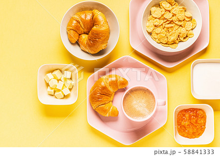 Coffee and croissants for breakfast on a yellow 58841333