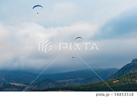 Paragliders couple on a background of clouds and Paragliders couple on a background of clouds and 58853518