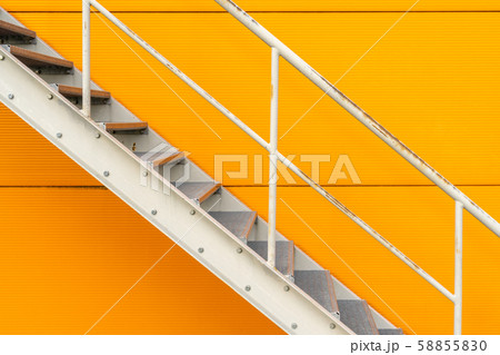 Steel stairs are on the side of the building wall 58855830