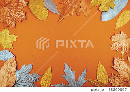 Autumn golden leaves frame on orange paper Autumn golden leaves frame on orange paper 58860097