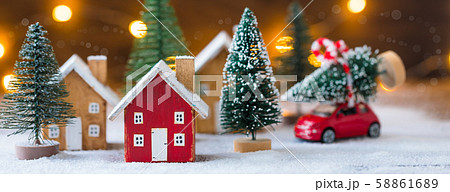 Miniature wooden houses and small red car with fir Miniature wooden houses and small red car with fir 58861689