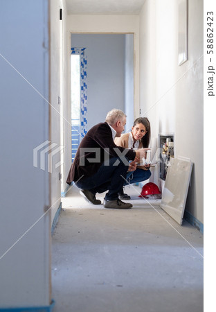 Architect Showing Heating System To Assistant In Construction Site 58862423