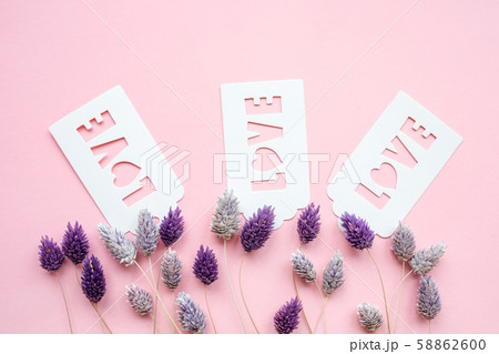 White gift tag with inscription love on a pink background. White gift tag with inscription love on a pink background. 58862600