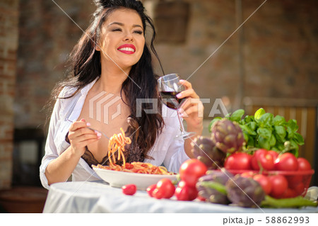 beautiful Woman in summer dress eats Italy 58862993