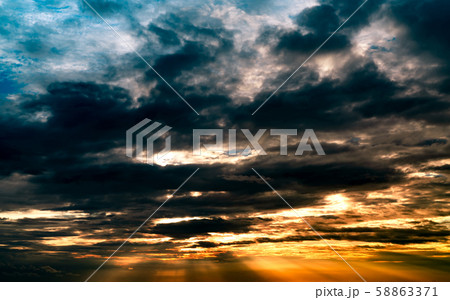 God light. Dramatic dark cloudy sky with sun beam. 58863371
