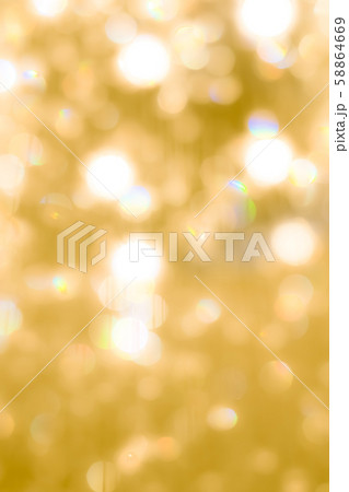 Blur yellow gold bokeh background of reflective glittering light from holiday party crystal ball chandelier 58864669