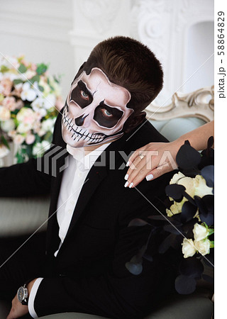A couple with skeleton make up for Halloween or All Souls Day 58864829