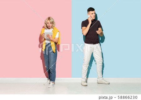Young emotional man and woman on pink and blue background 58866230