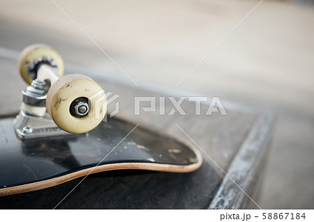 Close up of skateboard wheels in concrete skatepark on warm day Close up of skateboard wheels in concrete skatepark on warm day 58867184