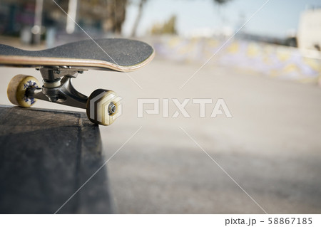 Close up of skateboard wheels in concrete skatepark on warm day Close up of skateboard wheels in concrete skatepark on warm day 58867185