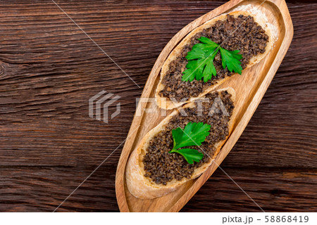 Fresh tasty bruschetta with truffle sauce and parsley. Top view Fresh tasty bruschetta with truffle sauce and parsley. Top view 58868419