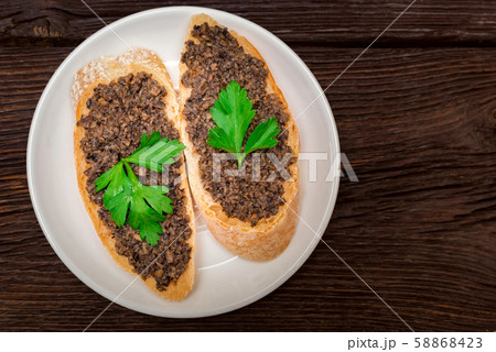 Fresh tasty bruschetta with truffle sauce and parsley. Top view Fresh tasty bruschetta with truffle sauce and parsley. Top view 58868423