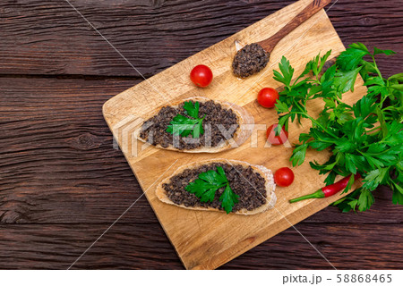 Fresh tasty bruschetta with truffle sauce, chili, parsley and tomates. Top view Fresh tasty bruschetta with truffle sauce, chili, parsley and tomates. Top view 58868465