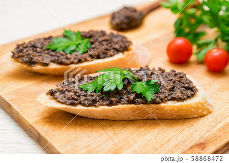 Fresh tasty bruschetta with truffle sauce, parsley and tomates 58868472
