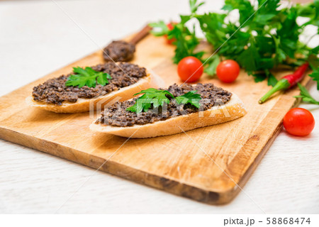 Fresh tasty bruschetta with truffle sauce, parsley and tomates Fresh tasty bruschetta with truffle sauce, parsley and tomates 58868474