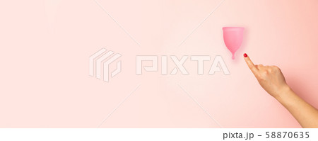 Female hand with red manicure points to a Female hand with red manicure points to a 58870635