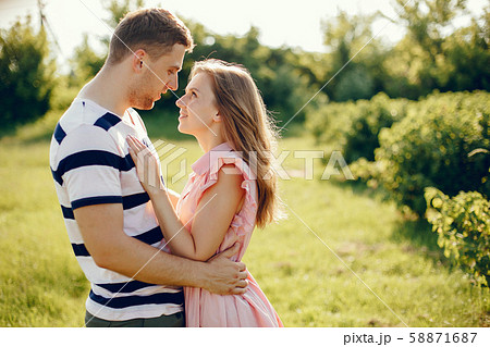 Beautiful couple spend time on a summer field 58871687
