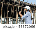 Male architect inspecting building house 58872066
